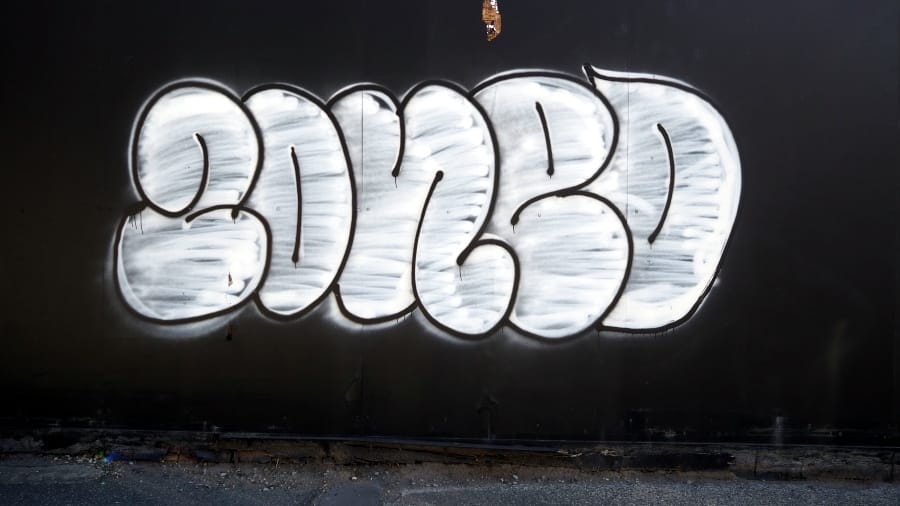 Graffiti on a hoarding that says "ZONED".
